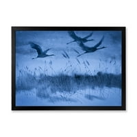 Dizalice u letu pod plavim večernjim svjetlom uokvirena slika umjetnički tisak na platnu